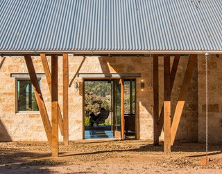 The porte cochère is the main entry to the house. A mahogany-and-glass pivot door allows you to see through the Great Room to the back porch and the valley beyond.