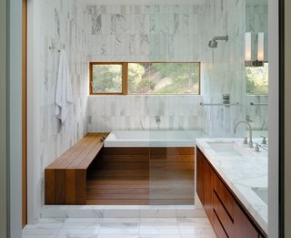 Wood meets white marble in this well-lit bathroom by architect Craig Steely. Contrasting materials make for a warm and serene bathing atmosphere in this Berkeley, California home.