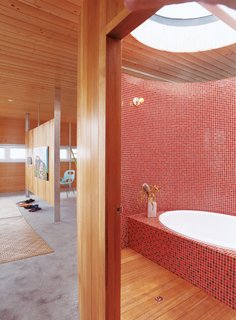 Fiery mosaics tile the majority of this Hawaiian tub room. Built and occupied by architect Craig Steely and his wife, the rest of the home is just as warm and tranquil aptly named Lavaflow 2.