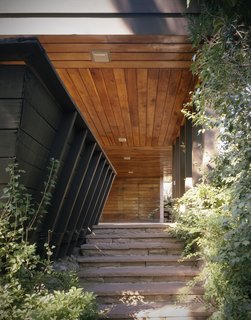 This is the first of two homes designed for the Vradenburg family by Ingraham and Ingraham, Architects. The overhang here serves as both coverage for the entrance and carport. Like Frank Lloyd Wright's designs, Ingraham tucked away her unusual entrances from obvious view. 