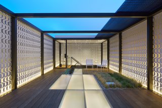 Translucent floor planks allow light to filter through a skylight in the kitchen below.