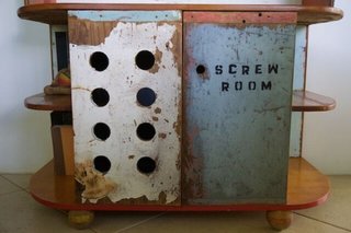 Distressed wood from salvaged boat wreck used on lower cabinets 