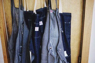 Denim aprons adorn the door to Grovemade's manufacturing wing.
