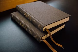 Two New Testament volumes of the new Reader's Bible in rich olive cloth-over-board bindings.