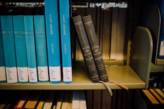 Two Reader's Bible volumes rest at an angle on the shelf at the Mt. Angel Abbey Library.