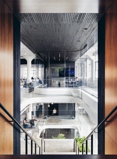 A Look Inside Squarespace NYC - Photo 8 of 10 - Vertical lines adorn ceilings and columns creating a rhythmic motion to this atrium space.