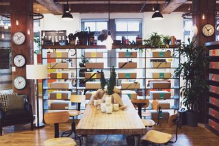 A table is decked for the holidays with shelving housing various home wares.