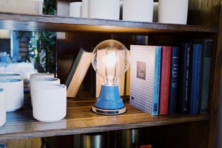 This light features a beautifully hued blue matte paint with a Russian birch plywood base attached to each handspun steel fixture.