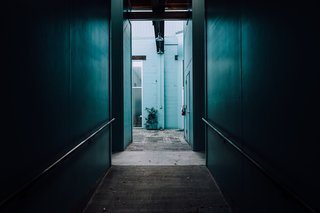 The Opinionated Leica Q - Photo 5 of 9 - Peering down a dark hallway into cerulean blue green.