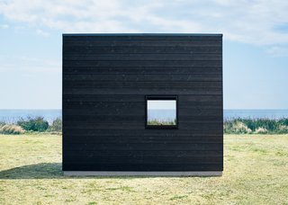 The Muji Hut is a Masterful Take on Minimalism - Photo 2 of 6 - Seeing the hut set against a vast seascape shows how the design allows the structure to be enveloped by the surrounding landscape.
