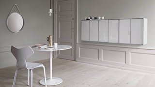 This wall unit mounted in a dining room makes for a subtle way to store dishes and tableware.