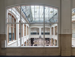 Formerly a Historic Bank, This Amsterdam Hotel Honors its Stately Roots - Photo 7 of 14 - A light-flooded view into the main historic bank hall from the second floor. 