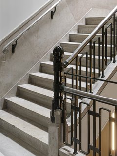 Formerly a Historic Bank, This Amsterdam Hotel Honors its Stately Roots - Photo 9 of 14 - A close-up detail showcases intricate ironwork on the building’s main staircase. 