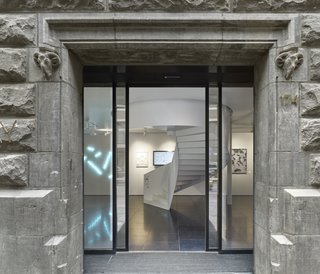 Formerly a Historic Bank, This Amsterdam Hotel Honors its Stately Roots - Photo 10 of 14 - The entrance to X Bank showcases modern works of Dutch art and design which contrast the concrete exterior.