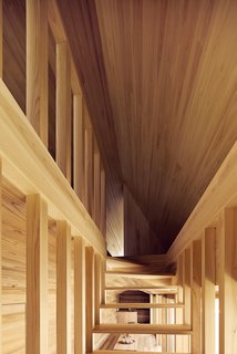 The open staircase is seen here from the front—showcasing the dynamic lines that converge at the top of the stairway leading to the bedroom space.
