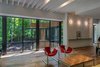 Reclaimed wood floors, recycled factory lights, and elements of the homeowners' art and furniture collection express the contrast between old and new. Photo 7 of Piedmont Retreat modern home