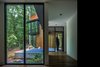 Modern home with Living Room, Recessed Lighting, and Dark Hardwood Floor. The lower level is intended for guests and includes two bedroom suites on opposite sides of the floor for privacy. Photo 11 of Piedmont Retreat