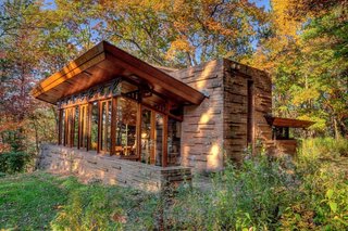 10 Frank Lloyd Wright Buildings We Love - Photo 2 of 10 - With a chimney that rises more than two stories, the Seth Peterson Cottage features an angled roof that frames views to the west and south.