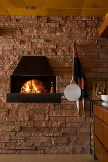 The wood-burning oven<br>may seem contemporary, but it’s actually a former<br>garbage incinerator now converted to cook pizza.