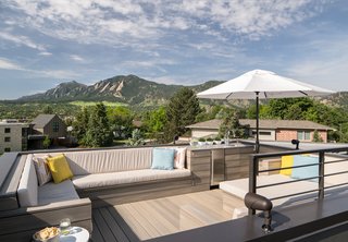 Inside Out - Photo 6 of 7 - The NewTechWood composite rooftop deck has 360-degree views that include the Front Range and downtown Boulder. "I call the deck ‘the icing on the cake,’" said the homeowner. The custom furniture was built to be large enough to allow for easy slumber parties (for both adults and kids) under the stars. 
