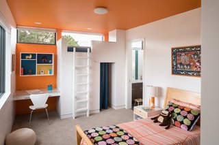 Inside Out - Photo 5 of 7 - This second- floor children’s bedroom is made for fun: A jungle gym on the far wall includes a curtained-off play space, and kids can climb by ladder up to a little bed where friends can gather or sleep over. (It is removable, so the room can be made into a more grown-up space in future years.) Using the animal artwork over the bed as inspiration, Goff added a playful giraffe table lamp from Alex Marshall Studio, IKEA Odestrad bedding, and Oeuf Sparrow Nightstands from All Modern. 