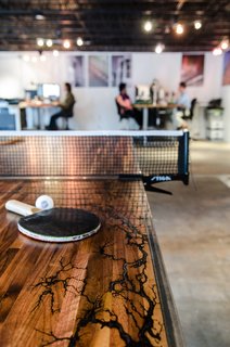 Once the electrical erosion was complete, Davis sanded down the table and added wax and epoxy to create a smooth, flush surface. When it's not being used for an afternoon ping pong match, Vertical Arts employees release the table into two halves that can be used for drawing, client engagement, or impromptu breakout sessions. 