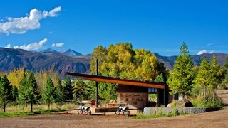 Black Shack Architects designed a modern motocross shelter in an elemental way.<br>When Glenn Rappaport’s long-time client approached him to design a shade structure along a private motocross track in El Jebel, Colorado, he was inspired by the elemental nature of the project. The family, with three teenage boys, wanted a shelter that would provide protection from the elements, a small changing area, restroom, fire pit, and storage for cold drinks.