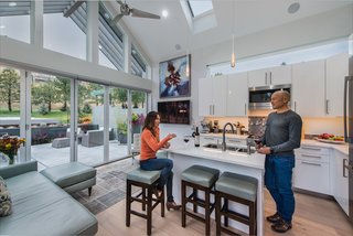 The highly efficient kitchen facilitates quick cooking as the food prep area, stove, and fridge can be reached in a single step. Creating such a streamlined design was far from simple however, as Garcia spent dozens of hours visualizing the space using tape outlines on the floor and creating numerous layouts using the IKEA kitchen design tool. Now living in the space they designed, Garcia notes that "even in the tiniest house, people still gather around the small bar in the kitchen. It really is the heart of the home." 