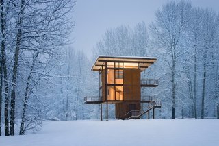 10 Tiny Cabin Homes That Will Have You Headed to the Forest - Photo 3 of 10 - Self-described by architect Olson Kundig Architects as "basically a steel box on stilts," the three-story cabin in upstate Washington can be completely sealed off to the elements with four 10’ by 18’ steel shutters that can be rolled over the glass windows when visitors clear out. 
