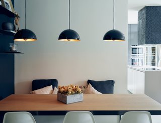 5 Main Ingredients For Cooking Up a Homey Kitchen Nook - Photo 2 of 8 - Three simple light fixtures with a pretty brass finish add a warm glow to a cool-toned room. 