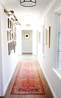 A beautiful and bold vintage runner adds color and pattern to create a dynamic hallway. 