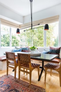 The very essence of California cool—black light fixture, leather chairs and a gorgeous vintage rug. 