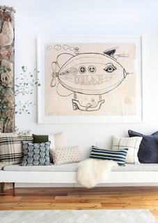 Quirky, oversized artwork paired with pretty pillows—always a win in our book. 