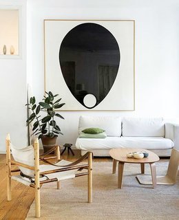 Graphic black and white artwork punctuates the bright, neutral space. 