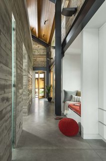 The central building connects the entry with the kitchen via long hallways. Concrete floors throughout the home—as well as the concrete center structure—keep the home cool in the summer and warm in the winter.