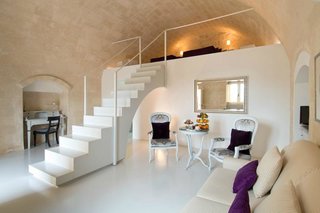 Ever Wanted to Stay in a Cave That’s Actually Pretty Modern Inside? - Photo 3 of 10 - Set within the cave dwellings of the ancient Italian city of Sassi de Matera, Italy, Sant'Angelo Luxury Resort combines the curving outlines and texture of natural stone with soft, modern touches.