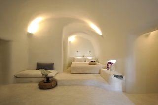 Ever Wanted to Stay in a Cave That’s Actually Pretty Modern Inside? - Photo 8 of 10 - Kapari Natural Resort in the 300-year-old village of Imerovigli on Santorini is pure bliss for those who like their interiors in white and earthy neutrals. The unique style of Cycladic architecture comes through beautifully in the organic lines of the smooth-edged walls, floors, and ceilings.