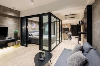 10 Modern and Stylish Places to Stay in Hong Kong - Photo 6 of 10 - This sleek apartment in Wan Chai was designed with a glass-partitioned bedroom cubicle that sits in the middle of the space. The open-concept kitchen is equipped with an oven, refrigerator, built-in washing machine, Nepresso machine, and a toaster.
