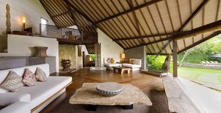 Set within a garden estate in Umalas, Villa Bali Bali is a collection of two- and three-bedroom, pitched-roof villas that can be rented separately or together to accommodate groups with as many as 15 people. It was built using natural materials including teak, rattan, and lava stone. 