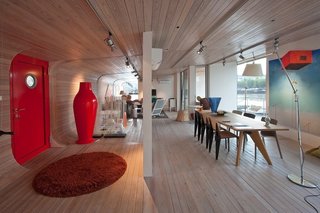 Moored in the stylish area of Holesovice in Prague, the sleek and contemporary Port X houseboat has floor-to-ceiling windows, outdoor terraces, a fully-equipped kitchenette, Italian sofa bed from Vlbieffe, and a Bang & Olufsen sound system. 