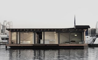 Moored in Lake Rummelsburg in Berlin, this 60-square-meter houseboat has full-height windows that open to views of the water and the city horizon. It has a large living area, open kitchen, and a fireplace—and can comfortably accommodate two adults and two children. 