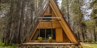 Sited on 20 acres of private land near Yosemite in the Sierra National Forest, these classic A-frame cabins have full-height glass windows, floating staircases, and tatami rooms with futon beds. 