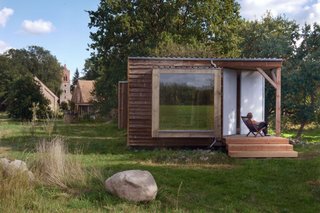 Salix summerhouse is part of Re:Hof Rutenberg, a former vicarage in the bucolic Uckermark area near Berlin that was transformed into a boutique vacation property. Designed by architect Peter Grundmann, the Salix cabin is built with panoramic windows and a glass-encased "bed-cube" that offers spectacular views of the surrounding paddocks.