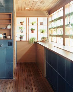 In this Toronto home, the windows of the combined laundry and bathroom look out into a courtyard from the second floor. 