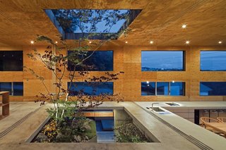 Blurring the boundaries between indoors and outdoors, this 1,300-square-foot home on the island of Honshu, Japan, by architect Keisuke Maeda has multiple windows and skylights surrounding its concrete base.