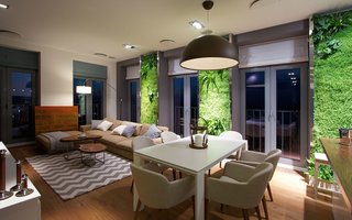 Thus Ukrainian apartment by SVOYA Studio has panels of green walls between the full-height windows that resemble modern versions of shag rugs.