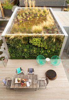 Cloaked in local flora on two sides with a grassy roof garden on top, this galvanized-box serves as a home studio for a jewelry designer in Vancouver.
