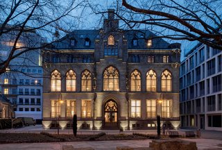 Vaulted ceilings, high window arches, and stone staircases are retained in the guest rooms and public spaces of this gothic-style city archive building, which is now a a stylish hotel that's furnished with 20th-century furniture designed by Walter Gropius, Charles and Ray Eames, and Ludwig Mies van der Rohe.