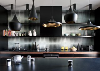 How to Design a Kitchen That’s Ideal For Entertaining—and Shop Our Picks - Photo 7 of 9 - This dark and bold kitchen features Beat Pendants by Tom Dixon and a black-and-white tile backsplash by Popham Design.