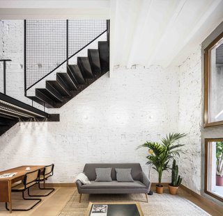 To retain and emphasize the traditional architecture of the building, the architects used natural terra-cotta for the floors, and stripped the paint from the walls to expose the beautiful textures and imperfections of the original brickwork.